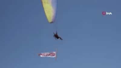 Yamaç paraşütü pilotu baba ve oğlu Van Gölü semalarında ‘Erciş il olsun’ pankartı açtı