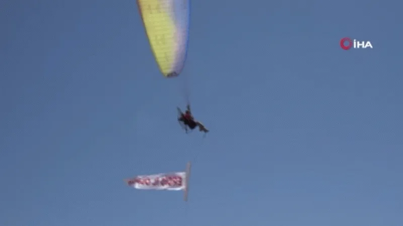 Yamaç paraşütü pilotu baba ve oğlu Van Gölü semalarında ‘Erciş il olsun’ pankartı açtı
